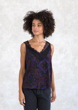 [Color: Black/Cobalt] A model wearing a vintage inspired lace tank top in a black and blue paisley bandana print. With a lace trimmed v neckline in front and back. 