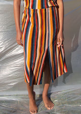 [Color: Black/Spice/Teal] A striped pleated midi skirt. Featuring a front slit. 