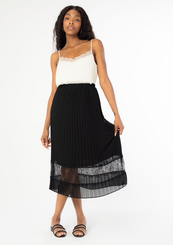 [Color: Black] A sunburst pleated mid length skirt. Featuring a delicate eyelash lace trim insert at the bottom of the skirt, an elastic waist, and elegant pleating throughout.