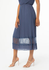 [Color: Steel Blue] A sunburst pleated mid length skirt. Featuring a delicate eyelash lace trim insert at the bottom of the skirt, an elastic waist, and elegant pleating throughout.