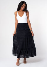 [Color: Black] A model wearing a bohemian black lace maxi skirt. 