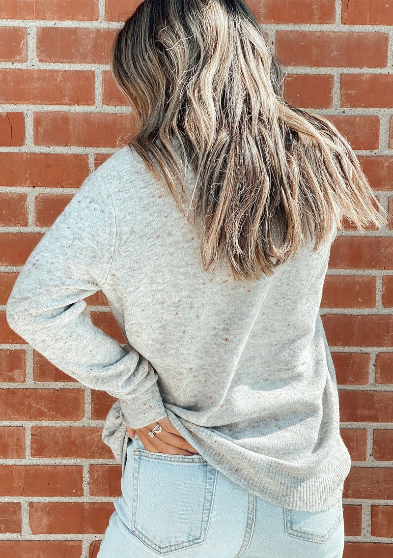 [Color: Grey Confetti] Speckled cross front sweater. Featuring a flattering v neckline and a whimsical confetti speckle throughout.