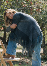 [Color: Charcoal Ombre] A model wearing a charcoal Ombre pattern cardigan sweater. With bohemian fringe detail, long sleeves, and an open front.  