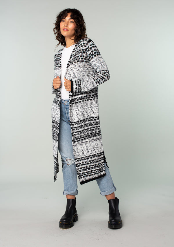 [Color: Black/Grey] A front facing image of a brunette model wearing a black and grey mixed knit long duster cardigan. 