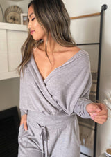 [Color: Heather Grey] Girl wearing a cozy surplice grey pullover top. 