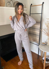 [Color: Heather Grey] Girl wearing a cozy surplice grey pullover top. 