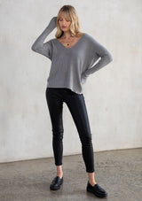 [Color: Heather Ash] A twist pullover in a soft fine gauge knit. Featuring a sexy back cut out detail, a relaxed silhouette with a bit of stretch, and a twist knot detail in the back.