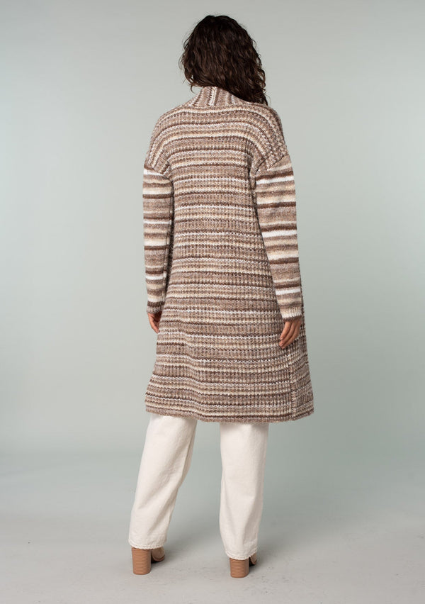 [Color: Brown/Taupe] A back facing image of a brunette model wearing a white and brown striped long cardigan. With an open front, contrast striped long sleeves, a shawl collar, and side pockets. 