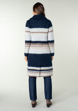 [Color: Ivory/Navy] A back facing image of a brunette model wearing a soft sweater coat in a blue and ivory stripe. With a button front, long sleeves, side patch pockets, and a notched lapel. 