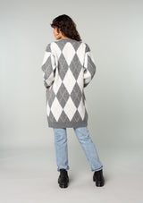 [Color: Charcoal/Grey] A back facing image of a brunette model wearing an ultra soft mid length cardigan in a grey and light grey argyle plaid pattern. With long sleeves, an open front, and side pockets. 