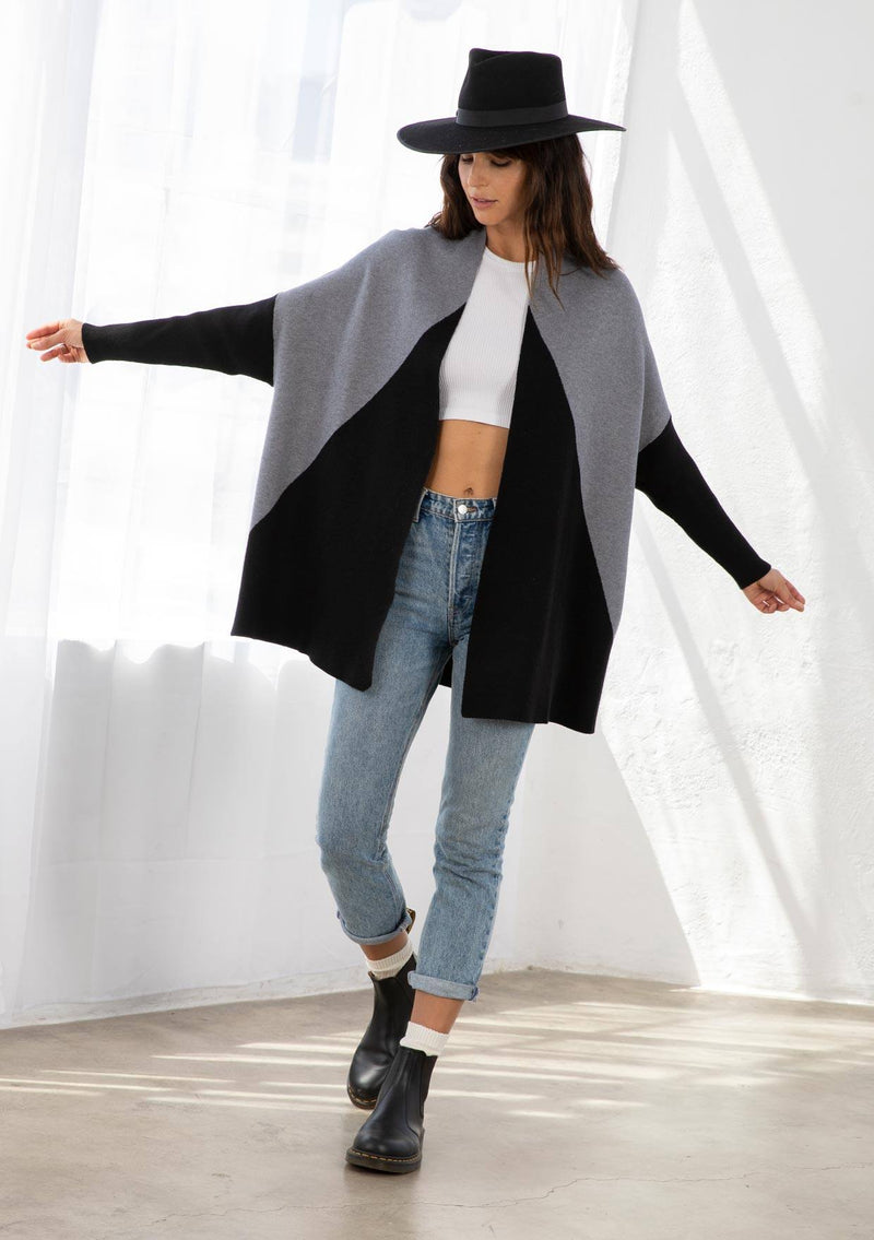[Color: Heather Grey/Black] A model wearing a grey and black color block cardigan. With long ribbed dolman sleeves and an open front. 