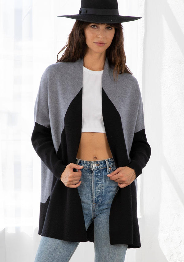[Color: Heather Grey/Black] A model wearing a grey and black color block cardigan. With long ribbed dolman sleeves and an open front. 