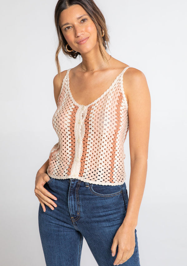 [Color: Sand/Clay] A model wearing a natural and pink crochet knit cropped tank top. 