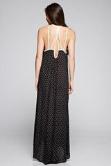[Color: Black/Vanilla] A back facing image of a brunette woman wearing a printed black v neck maxi dress with a strappy back.