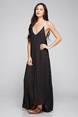 [Color: Black/Vanilla] A front facing image of a brunette woman wearing a printed black v neck maxi dress with a strappy back.