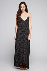 [Color: Black/Vanilla] A front facing image of a brunette woman wearing a printed black v neck maxi dress with a strappy back.