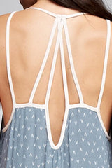 [Color: Slate Blue/Vanilla] A detail image of a brunette woman wearing a printed light blue v neck maxi dress with a strappy back.