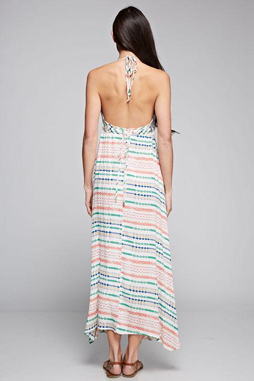 [Color: Natural Multi] A brunette model wearing a boho striped geo print halter maxi dress with a flowy shark bite skirt, open back, and a flattering v-neckline. 