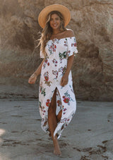 [Color: Vanilla Combo] A woman on the beach wearing an off shoulder floral print maxi dress. Featuring a front slit, short flutter sleeves, and a tie halter neck that can be tied multiple ways.