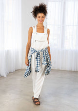[Color: White] A model wearing a white lightweight overall. Featuring a flattering drawstring waist. The perfect Fall overalls for layering or romping around. 