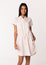[Color: White/Sand] A front facing image of a brunette model wearing a classic mini shirtdress in a white and sand stripe. With short cuffed sleeves, side pockets, a shirttail hemline, a button front, and a drawstring waist.