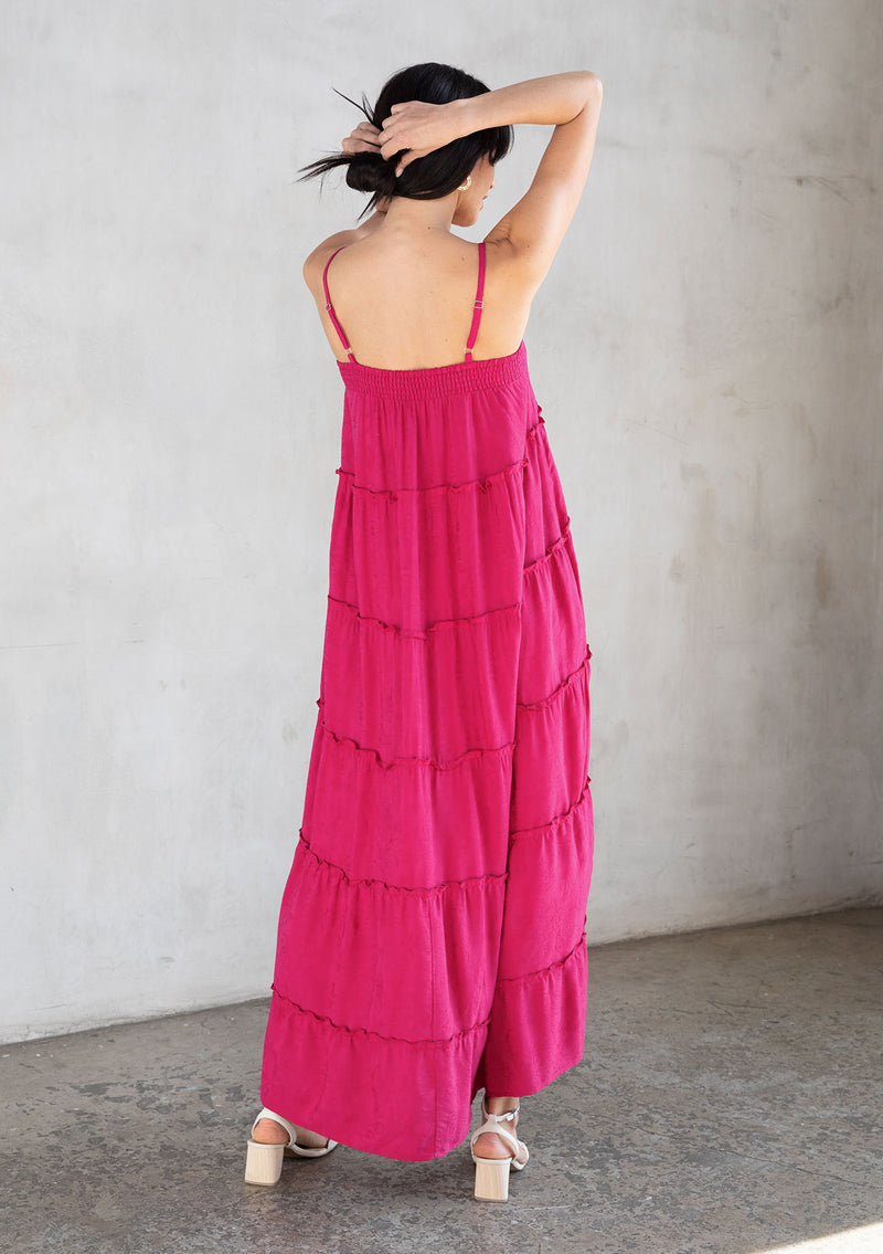 [Color: Mulberry] A model wearing an ultra flowy dark pink sleeveless maxi dress, featuring a sweetheart neckline, an empire waist, and ruffled details. Perfect beach dress.
