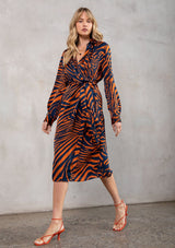 [Color: Dark Teal/Toffee] Stunning orange and blue zebra print mid length dress with long sleeves and a fabric belt. Model has styled this bold business dress with bright orange high heels.
