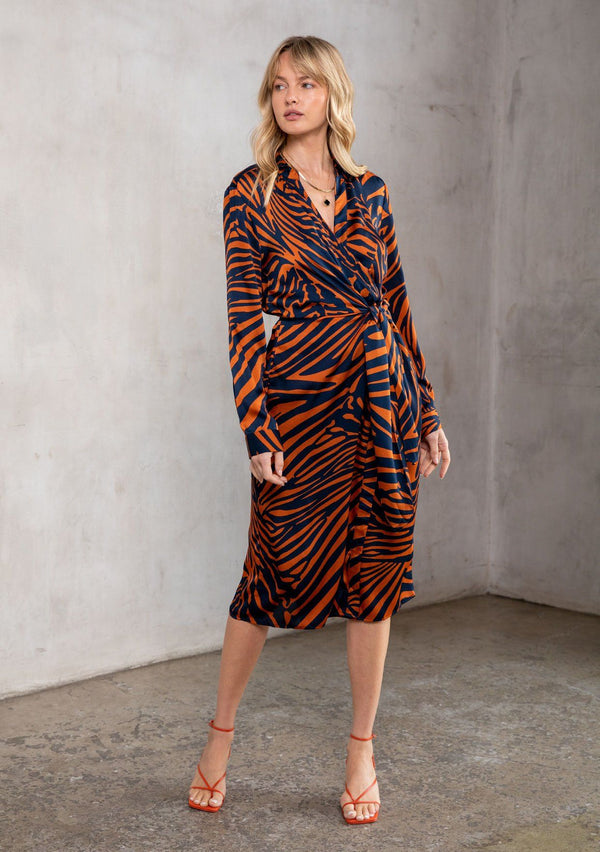 [Color: Dark Teal/Toffee] A soft and silky midi wrap shirt dress in a bold zebra stripe. A classic silhouette featuring a wrap front, a side tie closure, and a sexy surplice neckline.