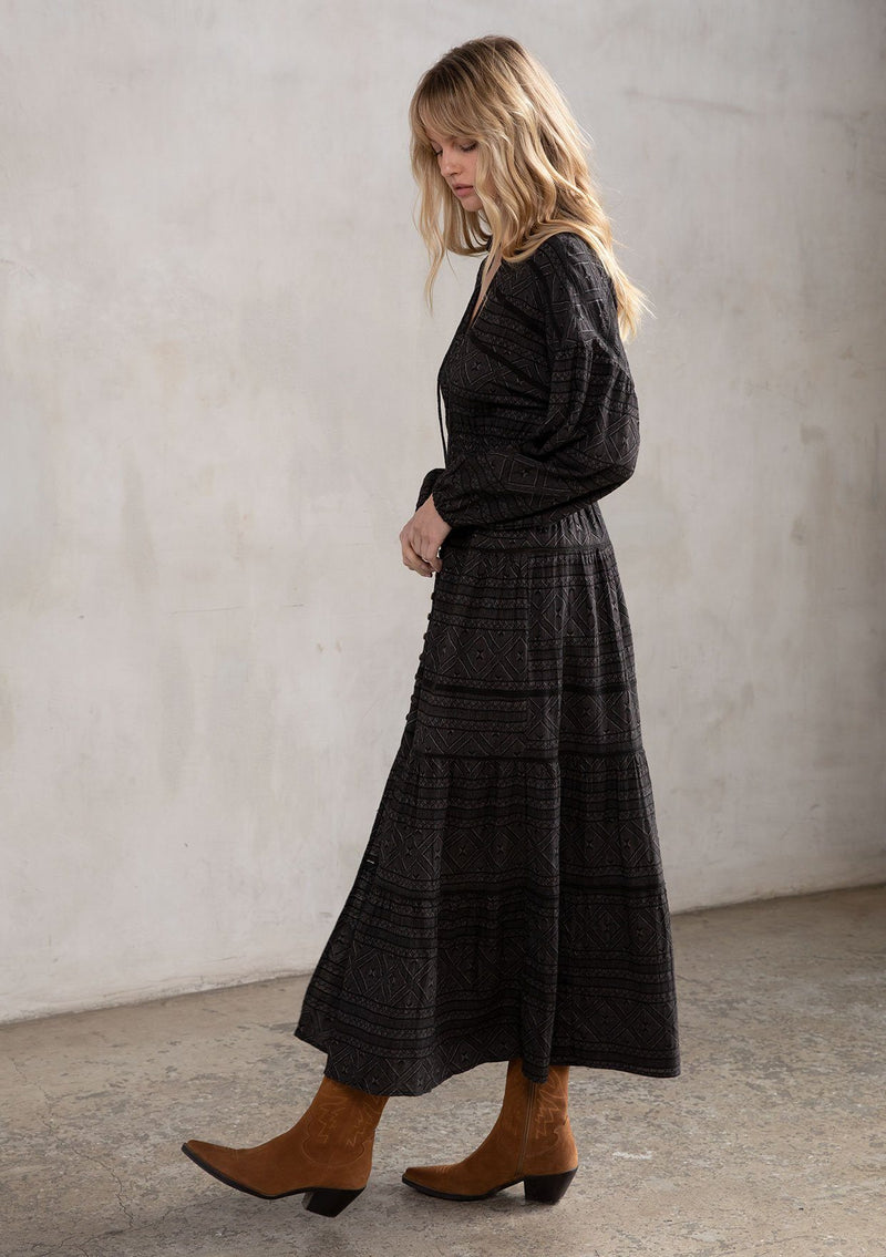 [Color: Black] A stunning maxi peasant dress. A classic bohemian silhouette featuring a button up front, a smocked elastic waist for definition, and voluminous long sleeves.