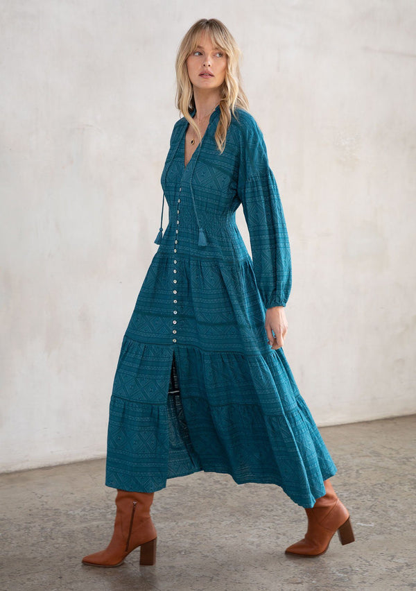 [Color: Teal] A stunning maxi peasant dress. A classic bohemian silhouette featuring a button up front, a smocked elastic waist for definition, and voluminous long sleeves.