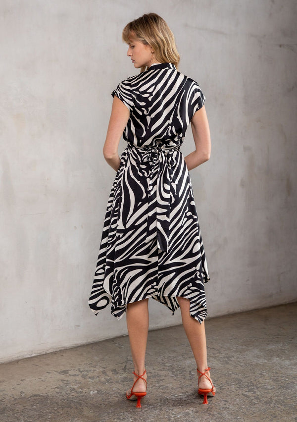 [Color: Black/Bone] A bold zebra stripe midi dress. Featuring a wrap around tie waist, short cap sleeves, and a handkerchief hemline.