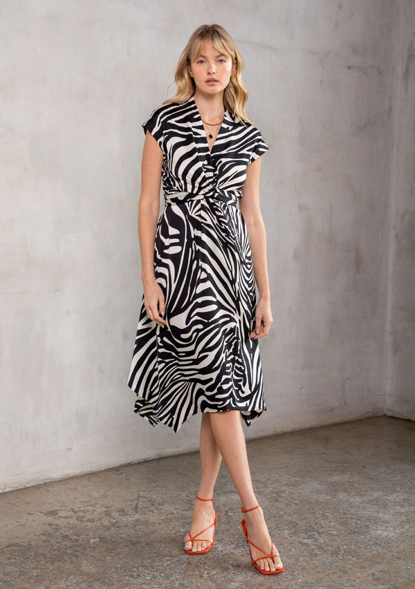 [Color: Black/Bone] A bold zebra stripe midi dress. Featuring a wrap around tie waist, short cap sleeves, and a handkerchief hemline.