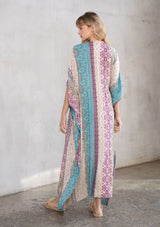 [Color: Mauve Multi] A model wearing a multi colored paisley print kimono. Featuring a tassel tie closure.