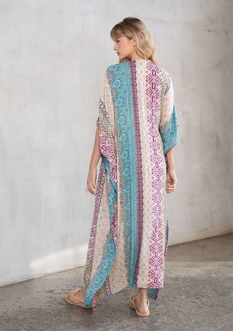 [Color: Mauve Multi] A model wearing a multi colored paisley print kimono. Featuring a tassel tie closure.