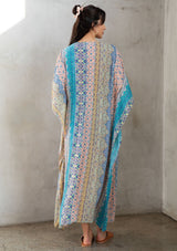[Color: Turquoise Multi] A model wearing a multi colored paisley print kimono. Featuring a tassel tie closure.