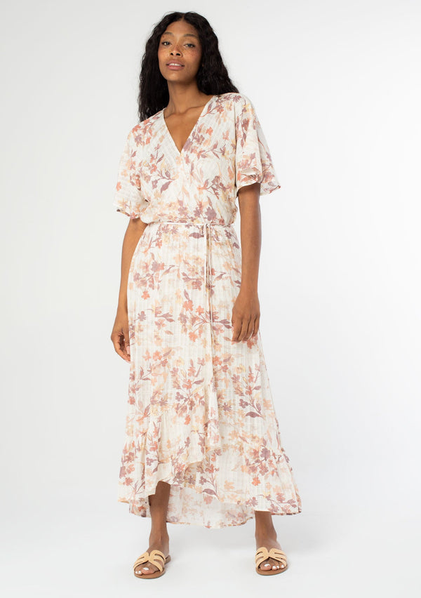 [Color: Peach Ivory] Beautiful and ultra feminine maxi dress featuring half length flutter sleeve and flirty ruffle hem. Soft and pretty floral print.