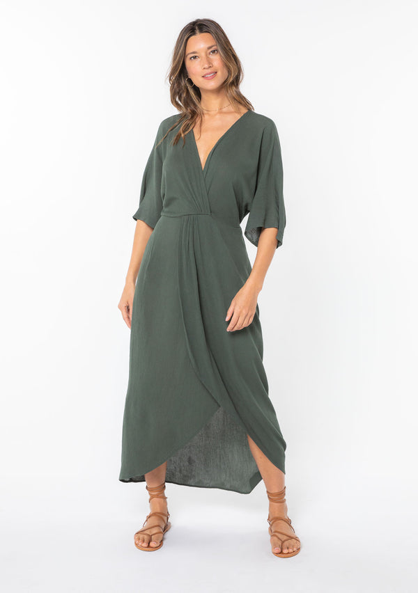 [Color: Military] A model wearing a military green maxi dress with a knot front detail and half length kimono sleeves.  