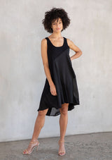 [Color: Black] A model wearing a sleeveless mini dress designed in a woven and knit mixed media patchwork. With a scooped neckline and attached lining.