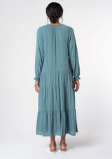 [Color: Sea Green] A model wearing a versatile aqua blue bohemian maxi dress. Features a classic peasant dress silhouette, a relaxed fit, and delicate textured dot details throughout.