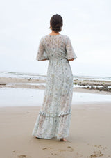 [Color: Mint/Rose] A sheer floral maxi dress with short flutter sleeves, a button front, a v neckline, and a tiered skirt.