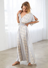 [Color: Natural/Grey] A model wearing a soft and silky mixed floral print maxi dress. With half length kimono sleeves, a smocked elastic waist, a deep v neckline, and an open back with tassel tie closure. 