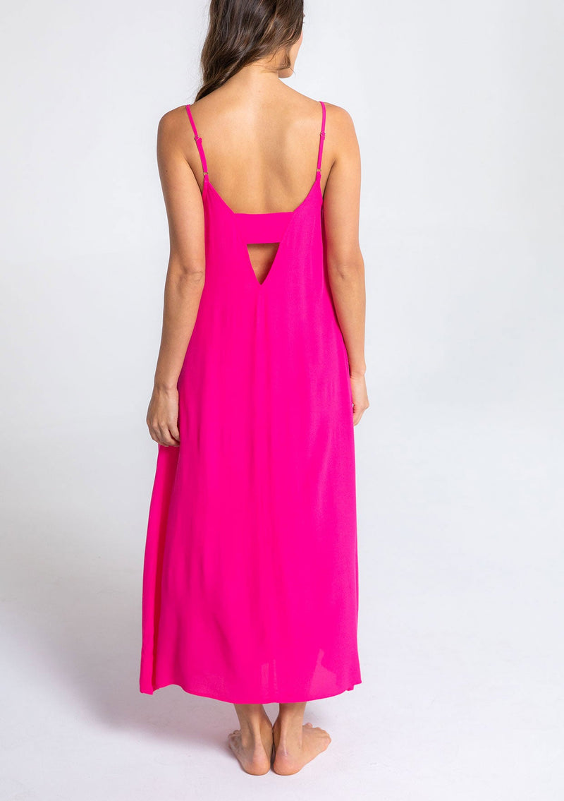 [Color: Hot Pink] A model wearing a sleeveless neon pink maxi dress. With adjustable spaghetti straps, a ruffle trimmed scooped neckline, and a v back with cutout detail.