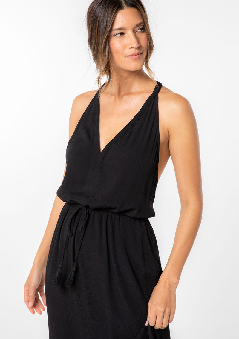 [Color: Black] A model wearing a sleeveless maxi dress. With a racerback, an adjustable drawstring waist, and v neckline.