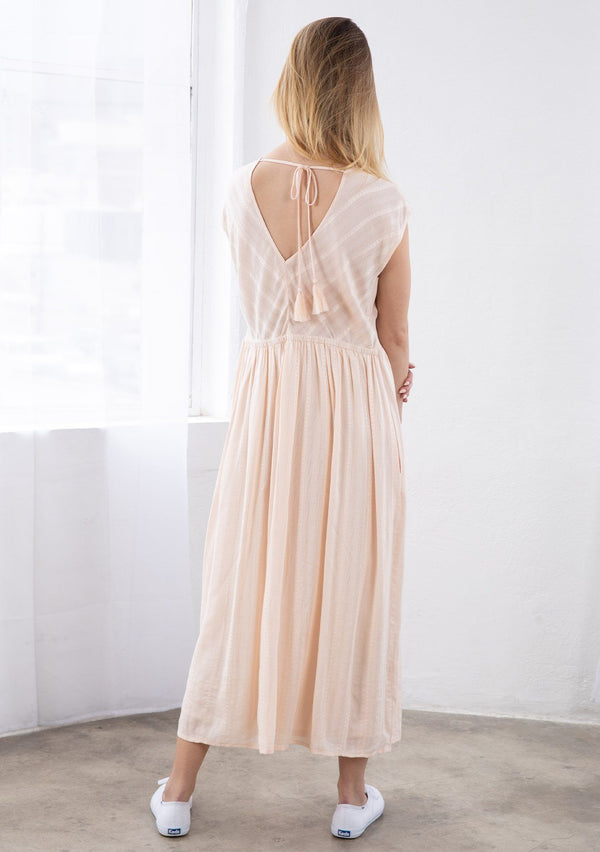 [Color: Natural] A relaxed fit maxi dress with short capped sleeves, a v neckline in front and back with a tassel tie closure, and a half elastic waist in the back.