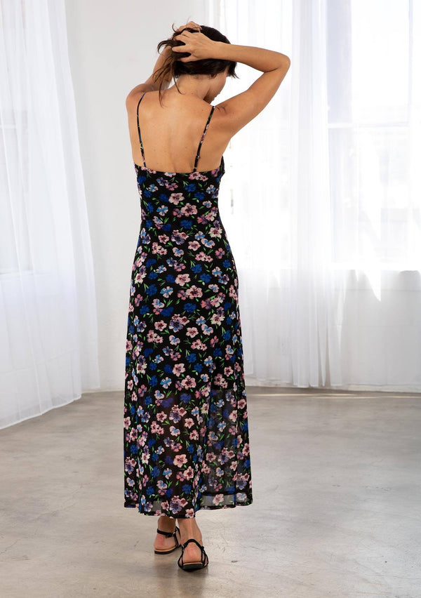 [Color: Black/Royal] A model wearing a black sheer mesh maxi slip dress in a blue and pink floral print. With adjustable spaghetti straps and a lace trim v neckline. 