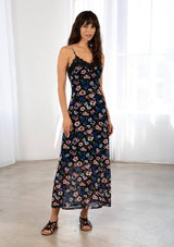 [Color: Black/Royal] A model wearing a black sheer mesh maxi slip dress in a blue and pink floral print. With adjustable spaghetti straps and a lace trim v neckline. 