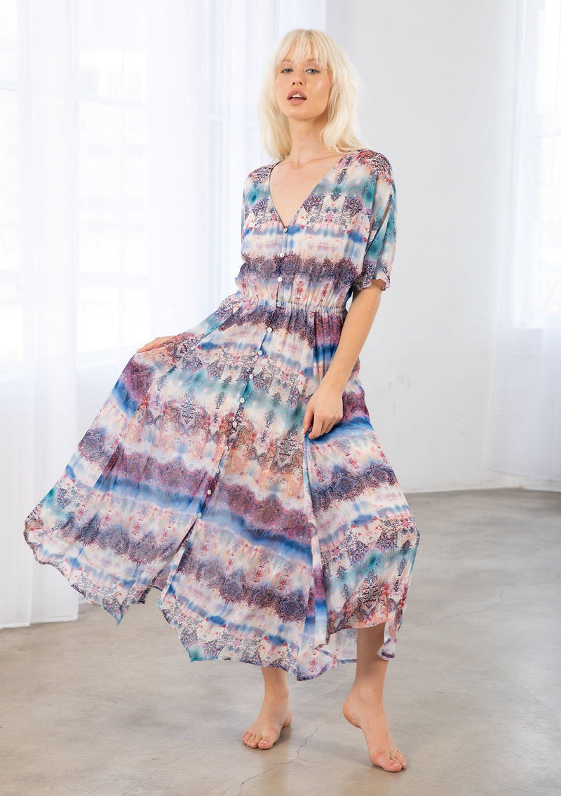 [Color: Cream/Navy] A model wearing a cream and navy sheer chiffon maxi dress in an abstract Ombre print. With a button front, an elastic waist, and short dolman sleeves. 