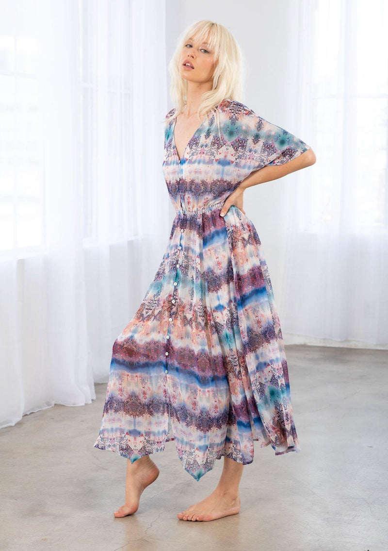 [Color: Cream/Navy] A model wearing a cream and navy sheer chiffon maxi dress in an abstract Ombre print. With a button front, an elastic waist, and short dolman sleeves. 
