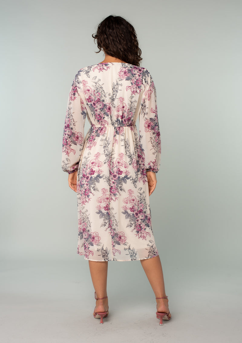 [Color: Natural/Wine] A back facing image of a brunette model wearing a sheer chiffon bohemian mid length dress in a natural and wine pink floral print. With voluminous long sleeves, a split v neckline, and an adjustable drawstring waist. 