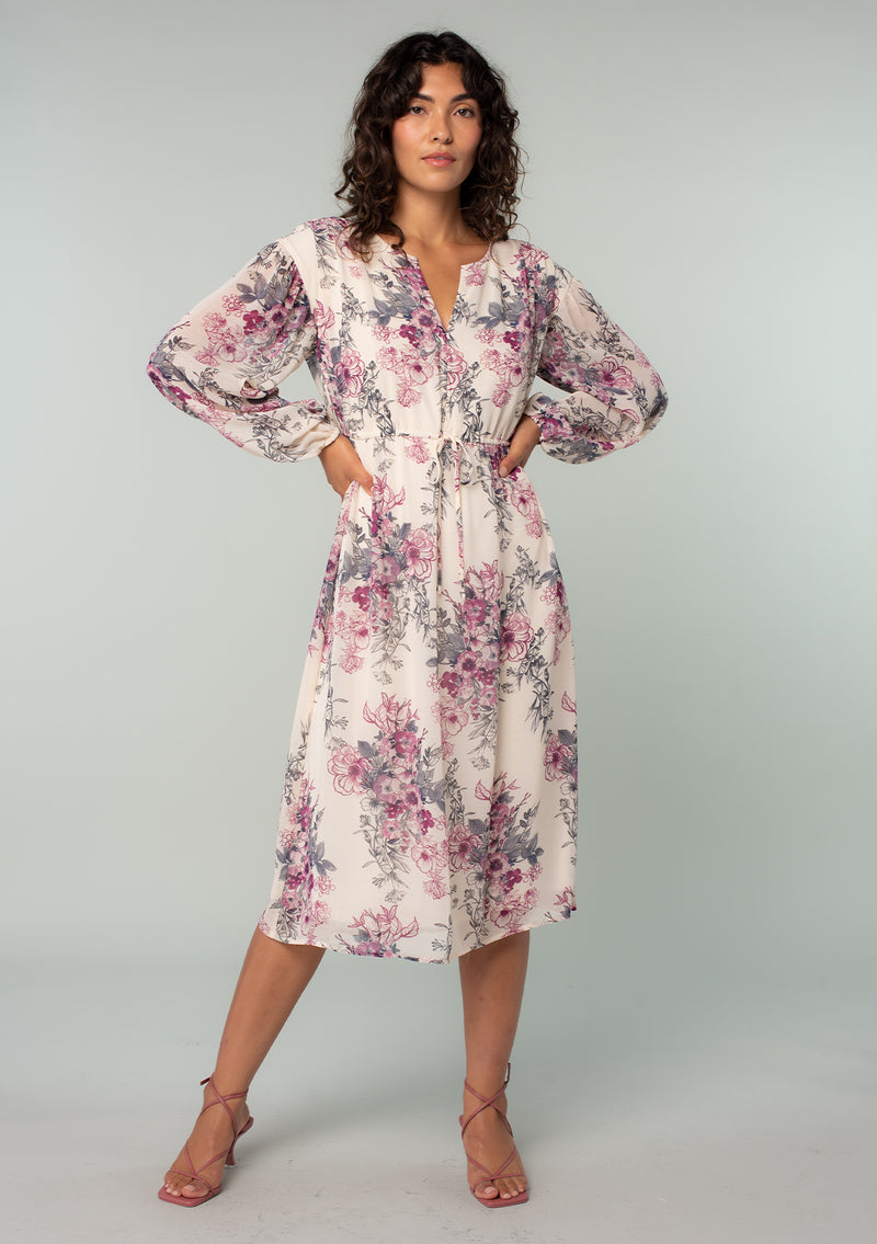 [Color: Natural/Wine] Ethereal and timeless, this classic white and pink Lovestitch midi dress is designed in a delicate floral print. Featuring sheer volume sleeves, unique pink and grey floral print, a split v-neckline, and a flowy skirt. The drawstring waist can be adjusted for added definition, or worn loose for a relaxed fit.  Available in XS through XL.